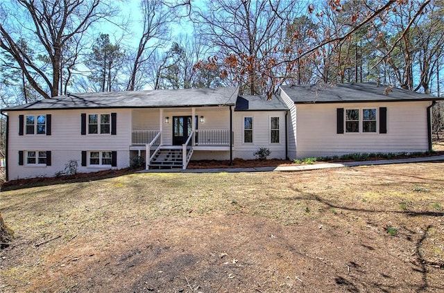 ranch-style home featuring covered porch, a front lawn, stairs, and brick siding