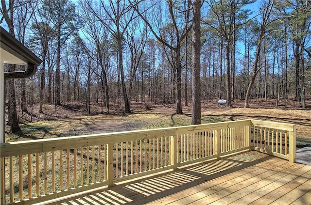 wooden terrace with a view of trees