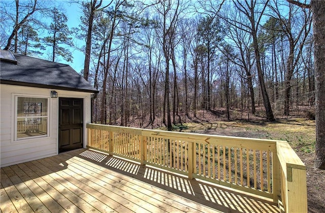 wooden deck with a view of trees