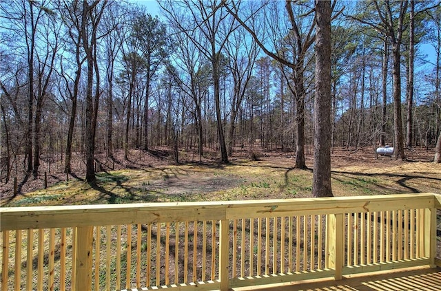 wooden deck featuring a forest view