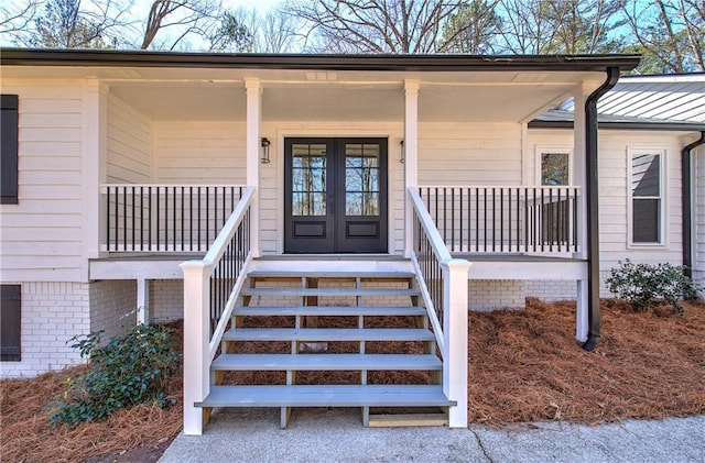 entrance to property featuring covered porch and french doors