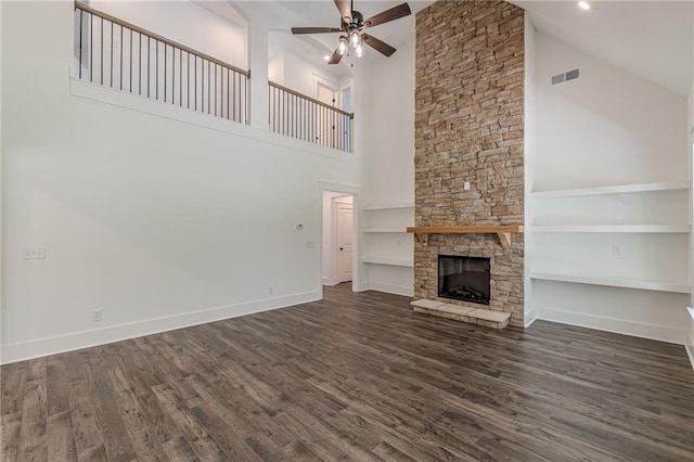 4075 O Henry Ct, Mcdonough, GA 30252 - unfurnished living room with high vaulted ceiling, a ceiling fan, a fireplace, dark wood finished floors, and baseboards