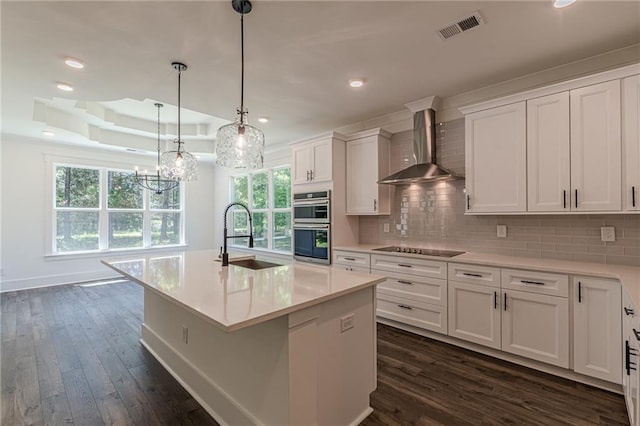 4075 O Henry Ct, Mcdonough, GA 30252 - kitchen featuring a sink, wall chimney range hood, dark wood finished floors, white cabinets, and recessed lighting