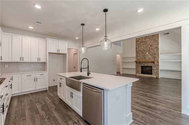 4075 O Henry Ct, Mcdonough, GA 30252 - kitchen featuring stainless steel dishwasher, a sink, white cabinets, light countertops, and an island with sink