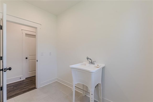4075 O Henry Ct, Mcdonough, GA 30252 - washroom featuring baseboards, light tile patterned floors, and a sink