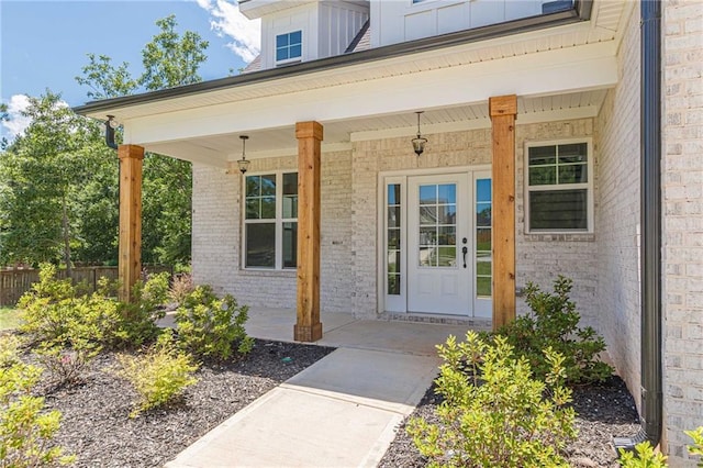 4075 O Henry Ct, Mcdonough, GA 30252 - view of exterior entry featuring brick siding, board and batten siding, and a porch