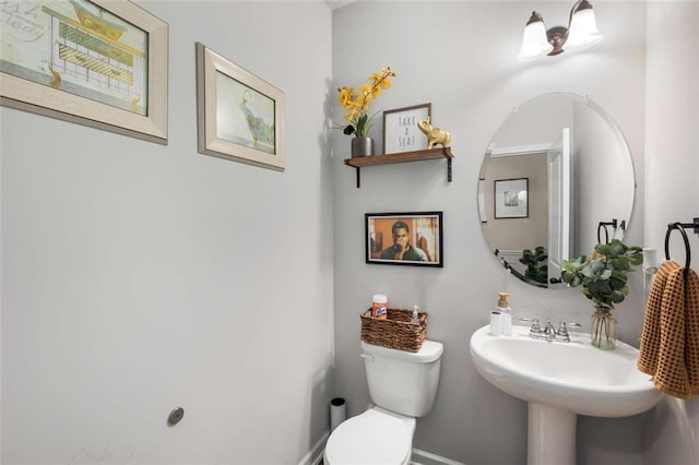 3406 Pennington Dr, Lithonia, GA 30038 - half bathroom with toilet, baseboards, and a sink