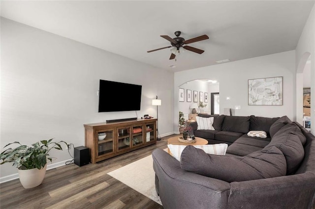 3406 Pennington Dr, Lithonia, GA 30038 - living area featuring arched walkways, ceiling fan, wood finished floors, and baseboards
