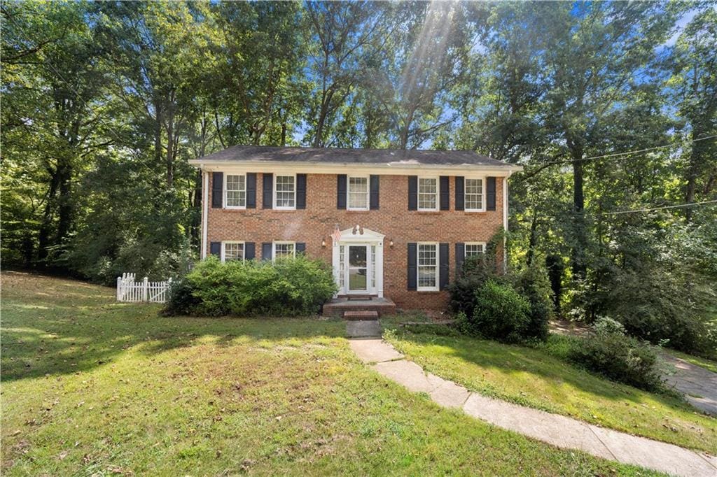 colonial home with a front lawn