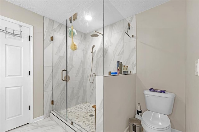 bathroom with walk in shower, toilet, and a textured ceiling