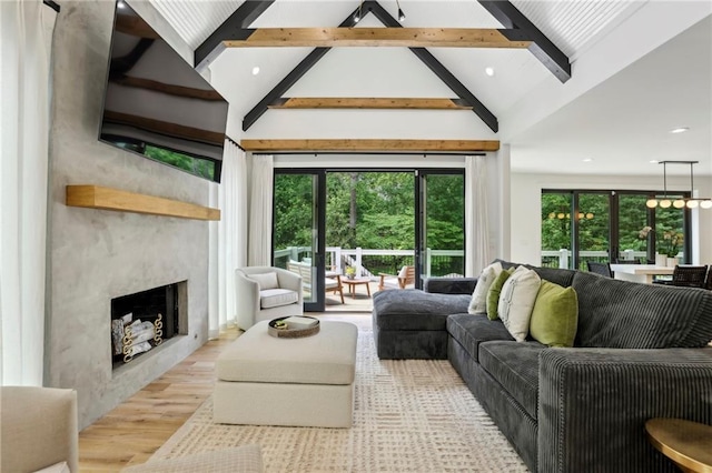 living room with beam ceiling, a fireplace, wood finished floors, recessed lighting, and high vaulted ceiling