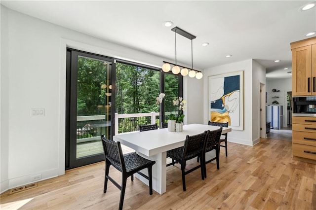 dining room with recessed lighting, light wood finished floors, and baseboards