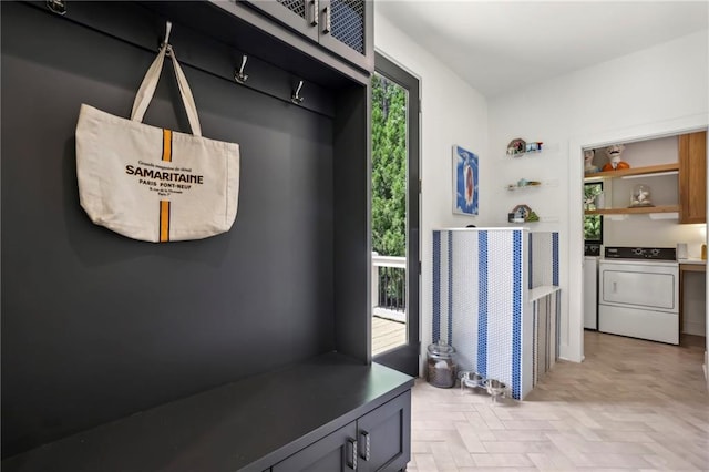 mudroom with healthy amount of natural light and washing machine and dryer