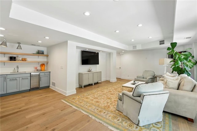 living area with wet bar, recessed lighting, light wood-type flooring, and baseboards