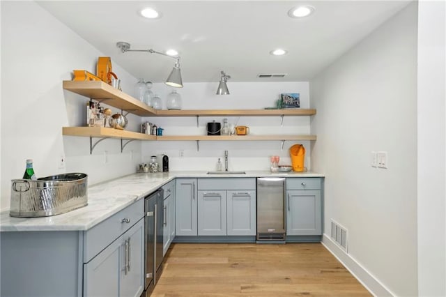 indoor wet bar featuring recessed lighting, light wood-style floors, and beverage cooler