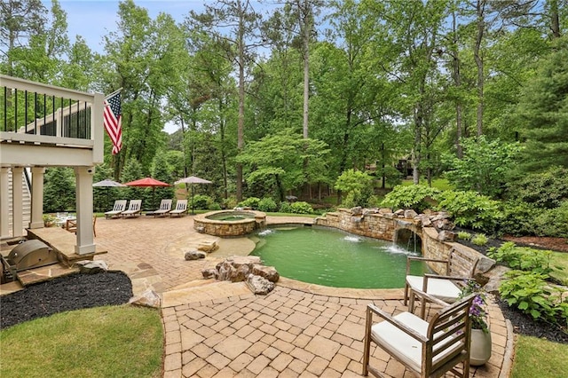 view of patio / terrace with a pool with connected hot tub and a garden pond