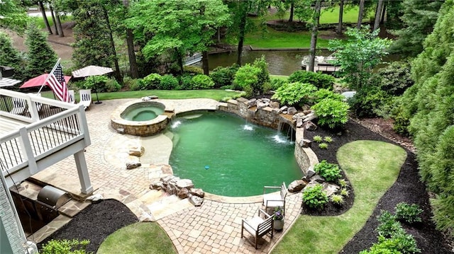 view of pool featuring a pool with connected hot tub and a patio area