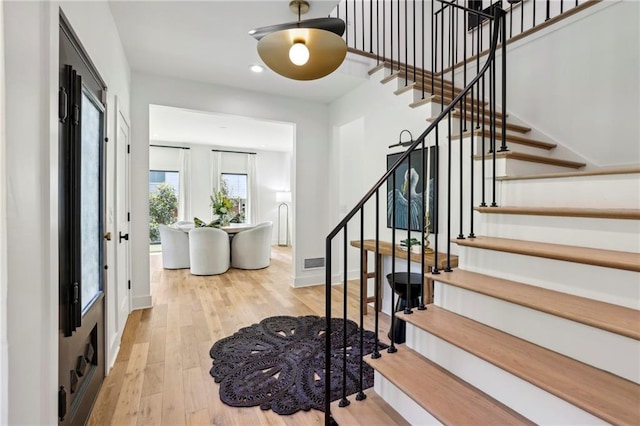 entryway featuring stairway, wood finished floors, recessed lighting, and baseboards