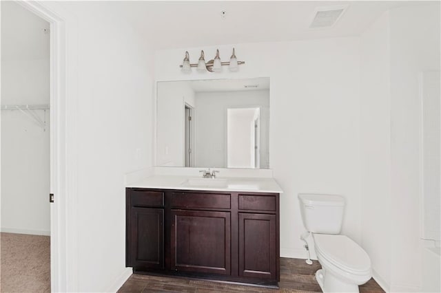 bathroom featuring toilet and vanity