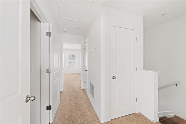 hallway with light colored carpet