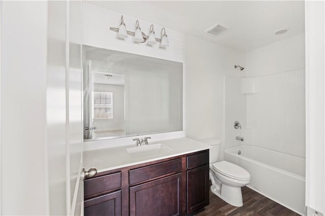 full bathroom featuring bathtub / shower combination, wood-type flooring, toilet, and vanity