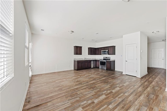 unfurnished living room with hardwood / wood-style flooring