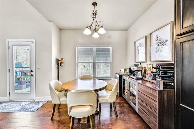 dining space featuring a notable chandelier and dark hardwood / wood-style floors