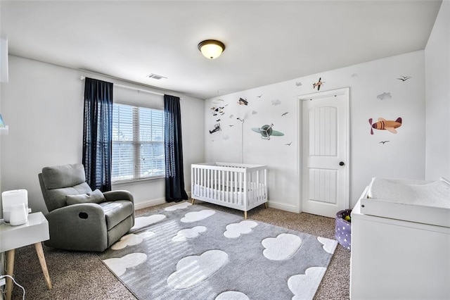 bedroom with carpet and a nursery area