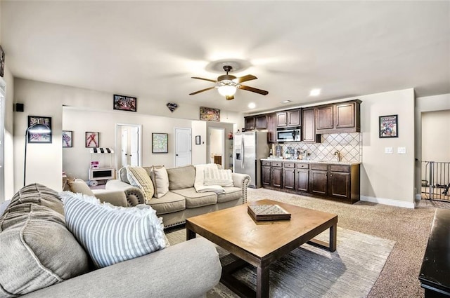 carpeted living room featuring ceiling fan