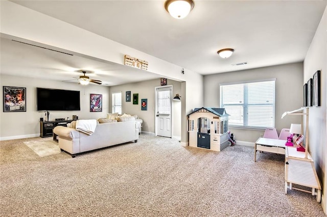 carpeted living room with ceiling fan