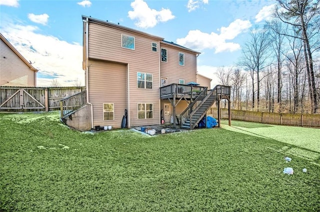 rear view of property featuring a deck and a yard