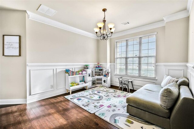 interior space featuring ceiling fan with notable chandelier, a high ceiling, hardwood / wood-style floors, and crown molding