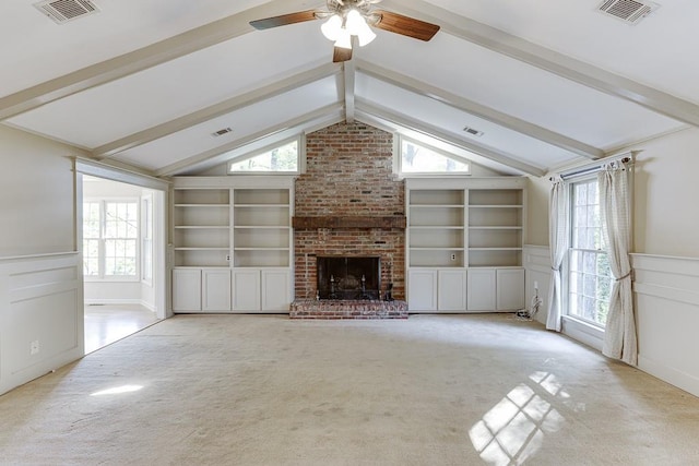 unfurnished living room with light carpet, a healthy amount of sunlight, and vaulted ceiling with beams