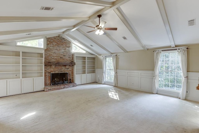 unfurnished living room with lofted ceiling with beams, plenty of natural light, and a fireplace