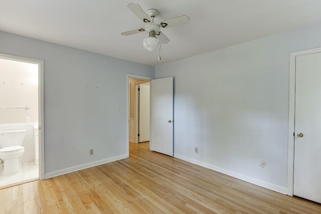 unfurnished bedroom featuring light hardwood / wood-style flooring, ensuite bath, and ceiling fan