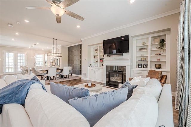 5005 Shay Town Ln, Peachtree Corners, GA 30092 - living room with a glass covered fireplace, a ceiling fan, recessed lighting, wood finished floors, and ornamental molding