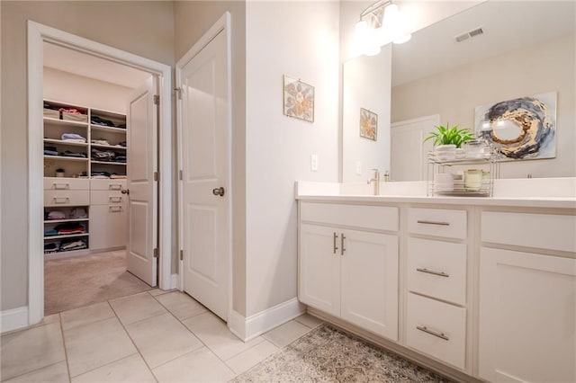 5005 Shay Town Ln, Peachtree Corners, GA 30092 - bathroom featuring a walk in closet, tile patterned flooring, double vanity, baseboards, and visible vents