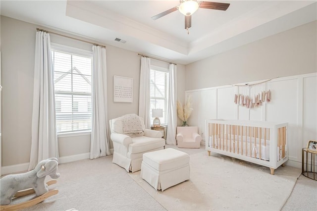 5005 Shay Town Ln, Peachtree Corners, GA 30092 - carpeted bedroom with a ceiling fan, visible vents, a nursery area, a raised ceiling, and a decorative wall