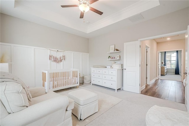 5005 Shay Town Ln, Peachtree Corners, GA 30092 - bedroom with visible vents, a decorative wall, light colored carpet, a raised ceiling, and a ceiling fan