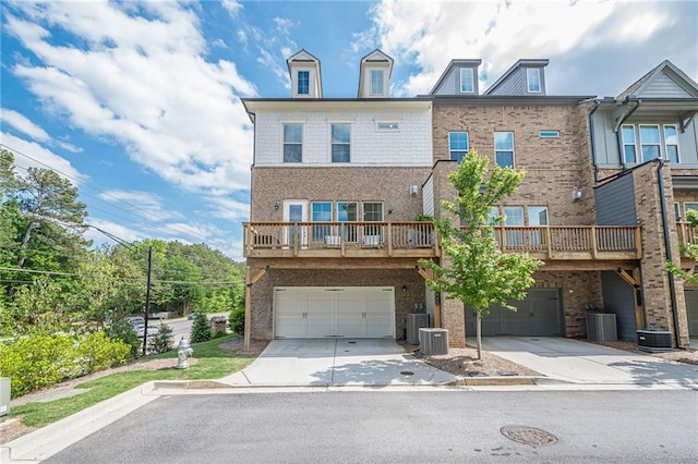 5005 Shay Town Ln, Peachtree Corners, GA 30092 - view of front of house featuring a garage, driveway, central AC, and brick siding