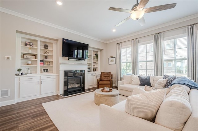 5005 Shay Town Ln, Peachtree Corners, GA 30092 - living area featuring a ceiling fan, visible vents, a glass covered fireplace, ornamental molding, and dark wood-type flooring