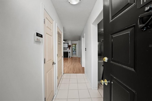 hall featuring light tile patterned floors