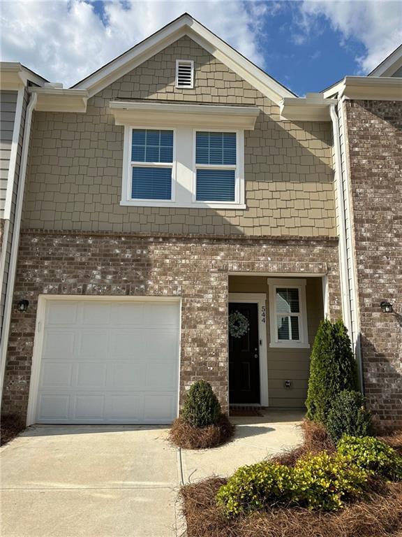 544 Magnolia Cir, Palmetto, GA 30268 - view of front of property featuring concrete driveway, brick siding, and an attached garage