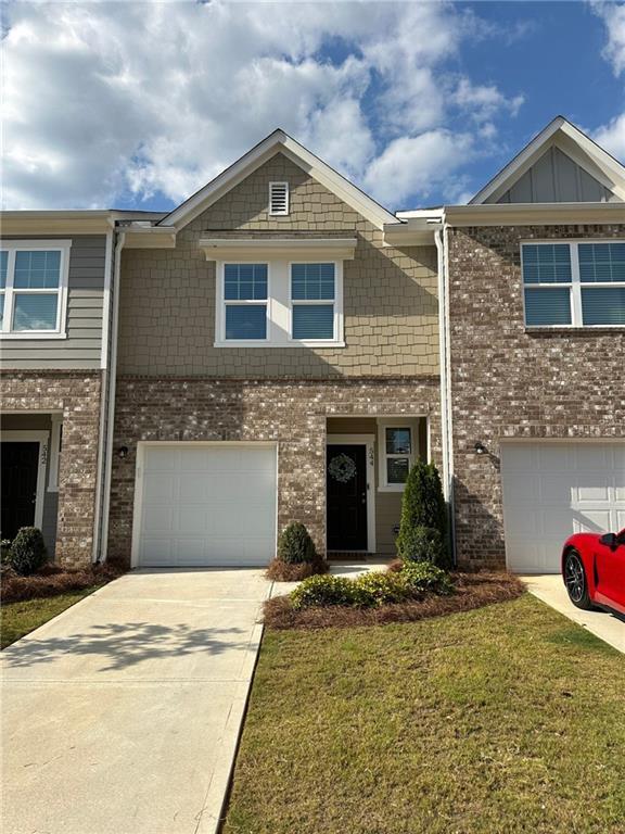 544 Magnolia Cir, Palmetto, GA 30268 - view of front facade featuring brick siding, driveway, a garage, and a front yard