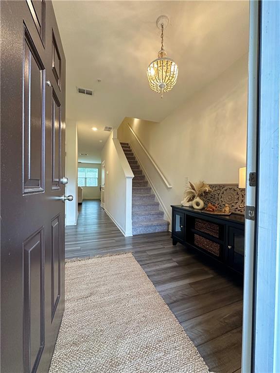 544 Magnolia Cir, Palmetto, GA 30268 - foyer featuring a chandelier, stairway, dark wood-type flooring, and recessed lighting