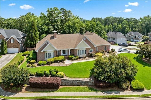 2012 Arbor Springs Way, Buford, GA 30519 - view of front of home with a chimney, brick siding, a front yard, a garage, and driveway