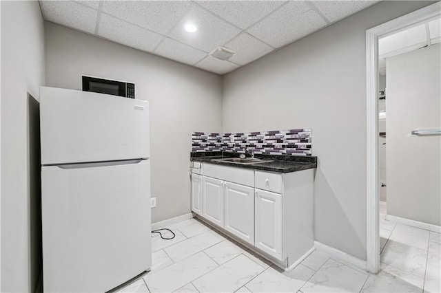2012 Arbor Springs Way, Buford, GA 30519 - kitchen featuring freestanding refrigerator, light marble finish flooring, dark countertops, decorative backsplash, and white cabinetry