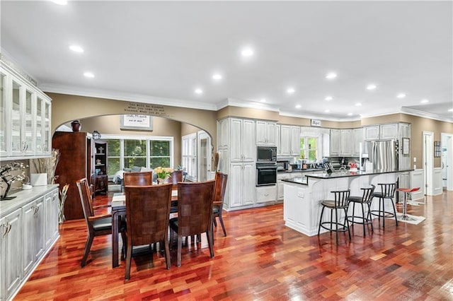2012 Arbor Springs Way, Buford, GA 30519 - kitchen featuring stainless steel fridge, built in microwave, oven, arched walkways, and a kitchen bar