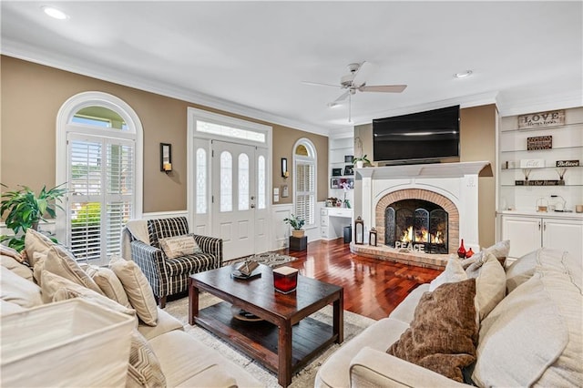 2012 Arbor Springs Way, Buford, GA 30519 - living room with crown molding, a ceiling fan, a brick fireplace, wood finished floors, and built in shelves