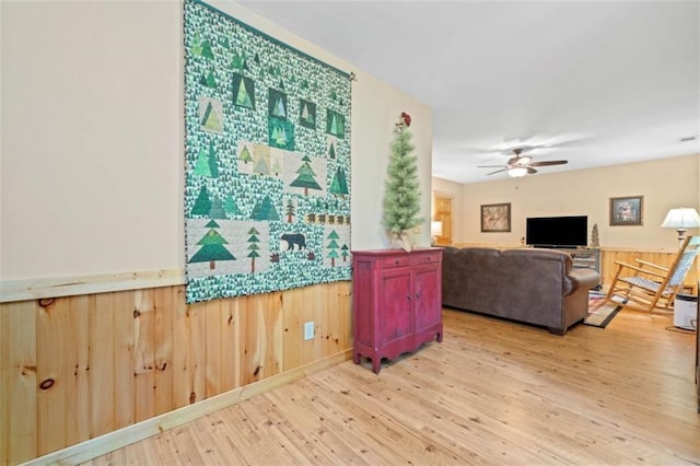 100 Julep Cir, Ellijay, GA 30540 - living area featuring light wood-style flooring, a ceiling fan, wood walls, and a wainscoted wall